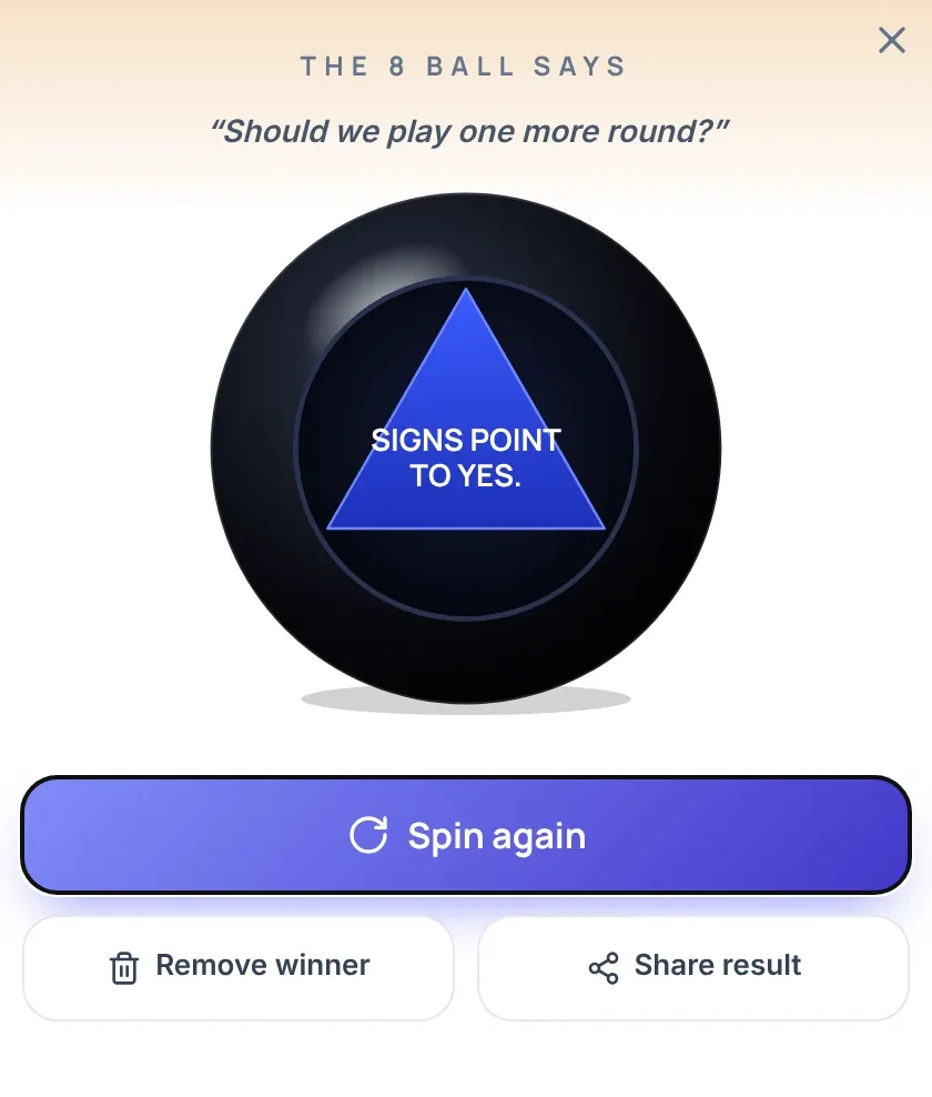 Result card of the magic 8 ball wheel titled "The 8 Ball says". It shows the question "Should we play one more round?" above a black 8 Ball whose blue triangle reads "Signs point to yes.", with the buttons Spin again, Remove winner and Share result.